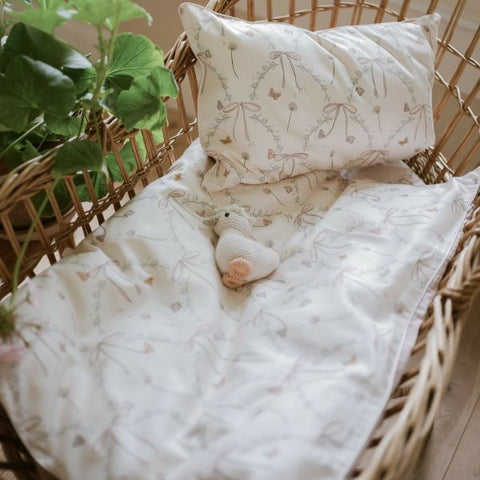 Bows & Butterfly Kisses Baby Duvet in Pink displayed in Moses Basket