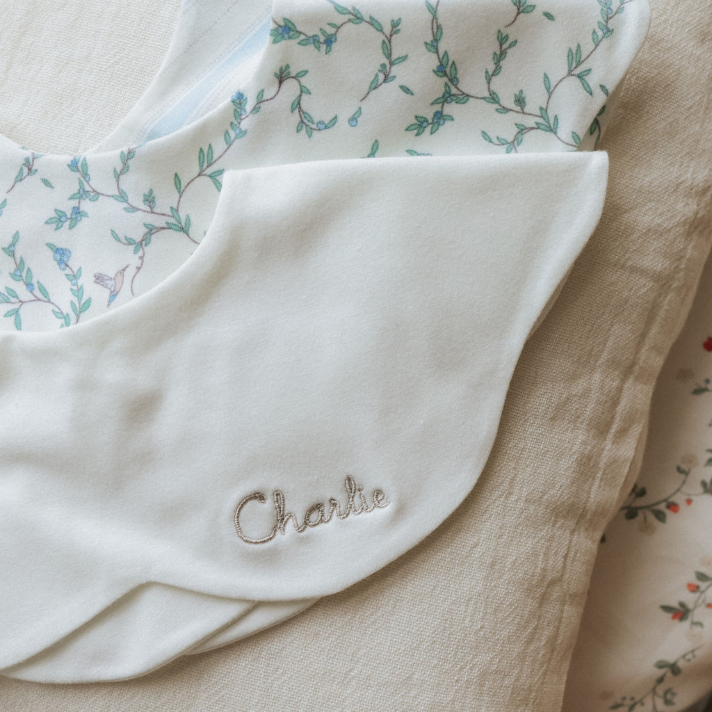 Winglet Bib in Ivory monogramed with child's name