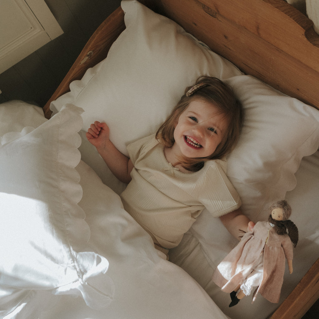 Personalize Me: Scalloped Starlight Twin Set in White with child smiling laying in bed